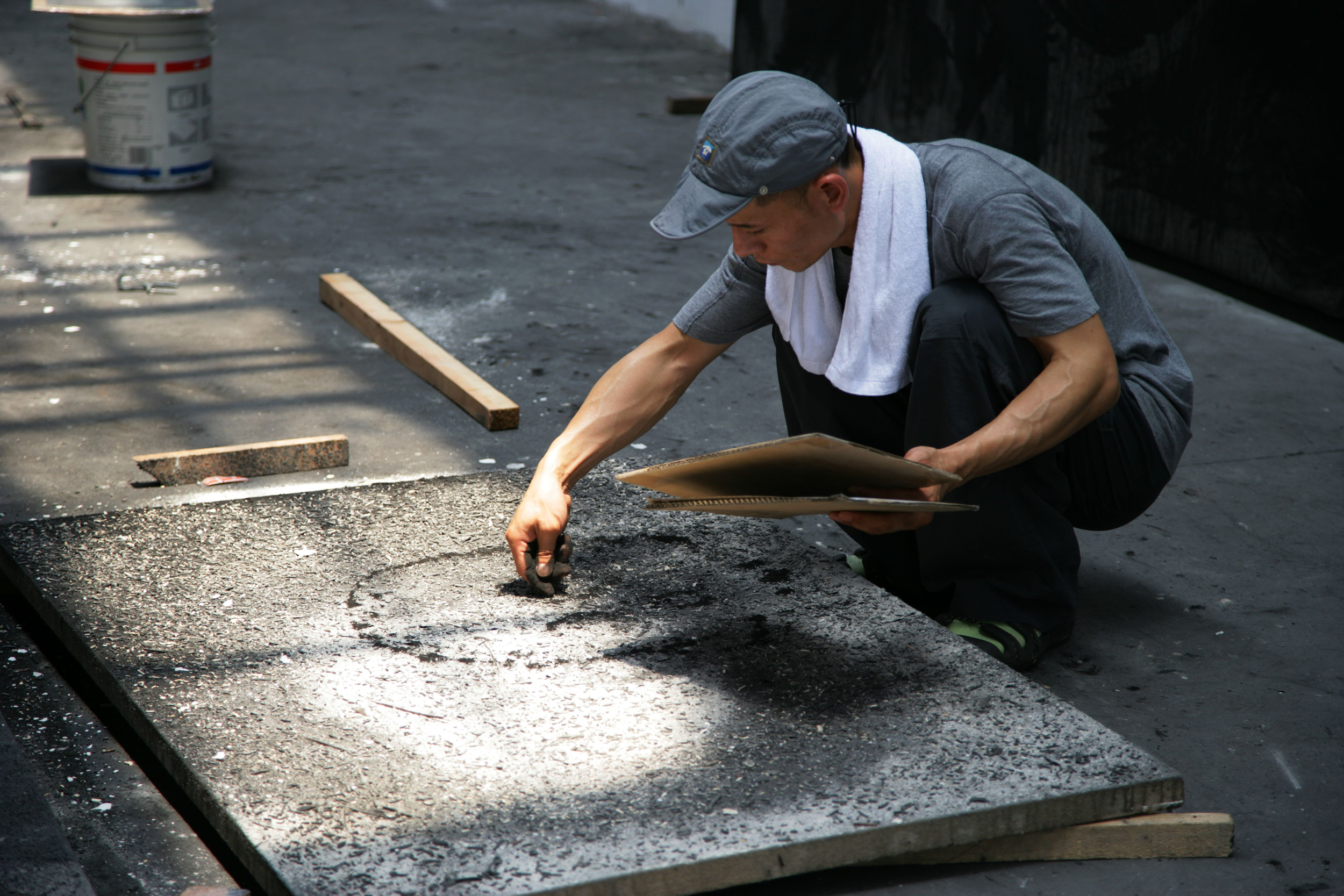 Zhang Huan applying ash to a painting. Photo courtesy of the artist and Pace Gallery.